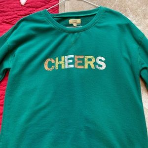 Green sweater that says CHEERS